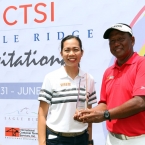ms bambi marfil-ictsi, asst.pr manager awards the champion trophy to mr tony lascuna