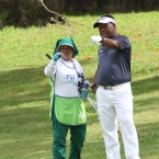 lascuna checking his line with his caddie