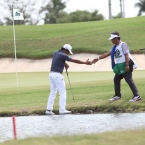 juvic pagunsan assited by his caddie while he is in troubled in hole 5