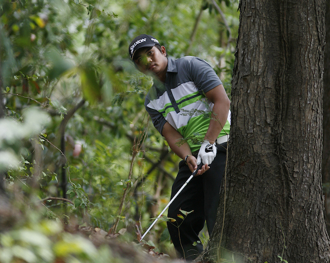 Clyde Mondilla punches out from under the tree on No. 5.
