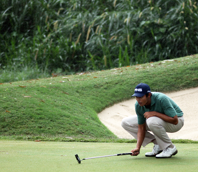 Johannes Veerman of the US reads the line of his putt on No. 11