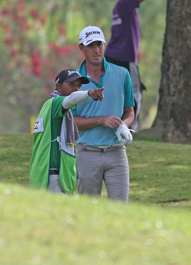 Nicolas Paez gets a help from caddie for his target on No. 2