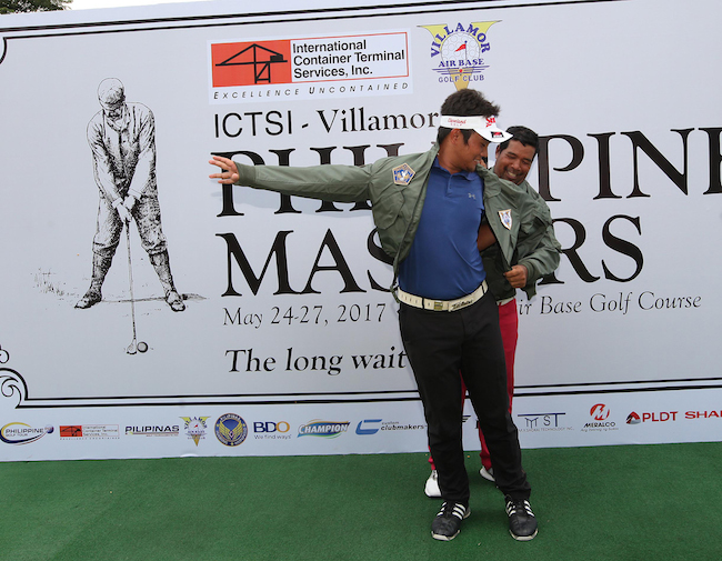 Cassius Casas, the last Masters champ in 2000, helps Clyde Mondilla don the Masters jacket following a come-from-behind victory in the revival of one of the country's former four major championships at its home at the Villamor Golf Club.