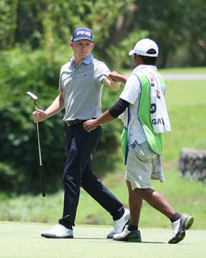 John Michael O’Toole makes a fist-bump with his caddie after drilling in a clutch birdie on No. 16.