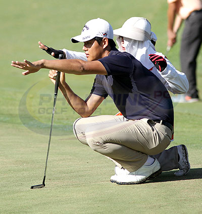 Lee Seongki gets a little help from his caddie as they read the line of his putt on No. 3