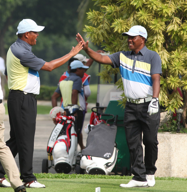 South Tony Lascuña (right) gets a high-five from Orlan Sumcad as they warded off North’s Gerald Rosales and Keanu Jahns in the foursomes of The Duel 4 at Wack Wack.