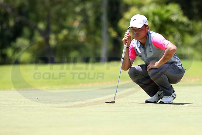 Miguel Tabuena reads the line of his putt on No. 2