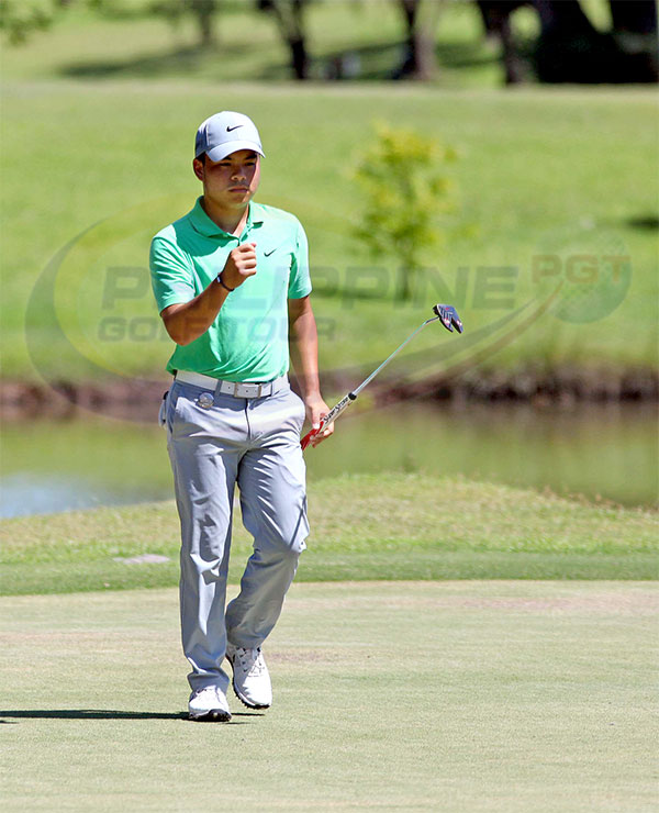 Miguel Tabuena pumps his fist after drilling in a birdie putt on No. 12