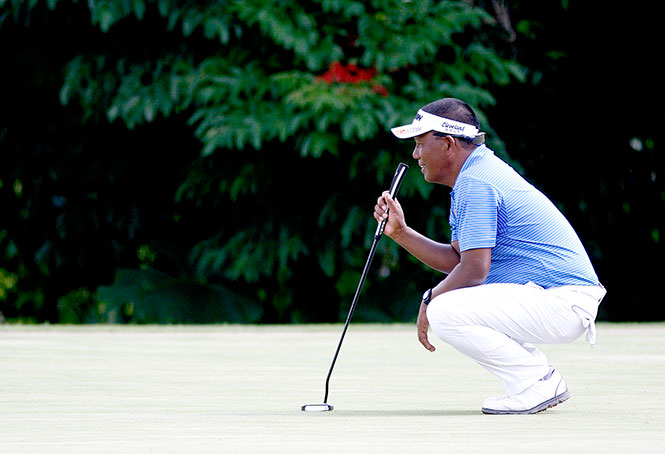 Tony Lascuna reads the line of his birdie putt on No. 5