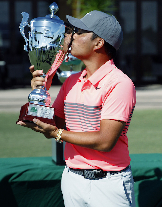 Miguel Tabuena kisses his huge The Country Club Invitational trophy.